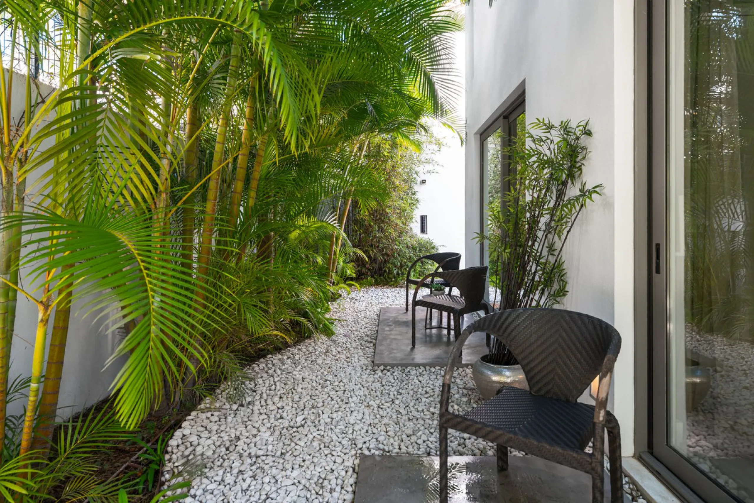 A semi-detached villa in the urbanisation, four bedrooms, four bathrooms, arranged with intent rather than habit: basement level below, an entrance floor with three en-suite bedrooms and a calm water feature setting the tone, a first floor dedicated entir