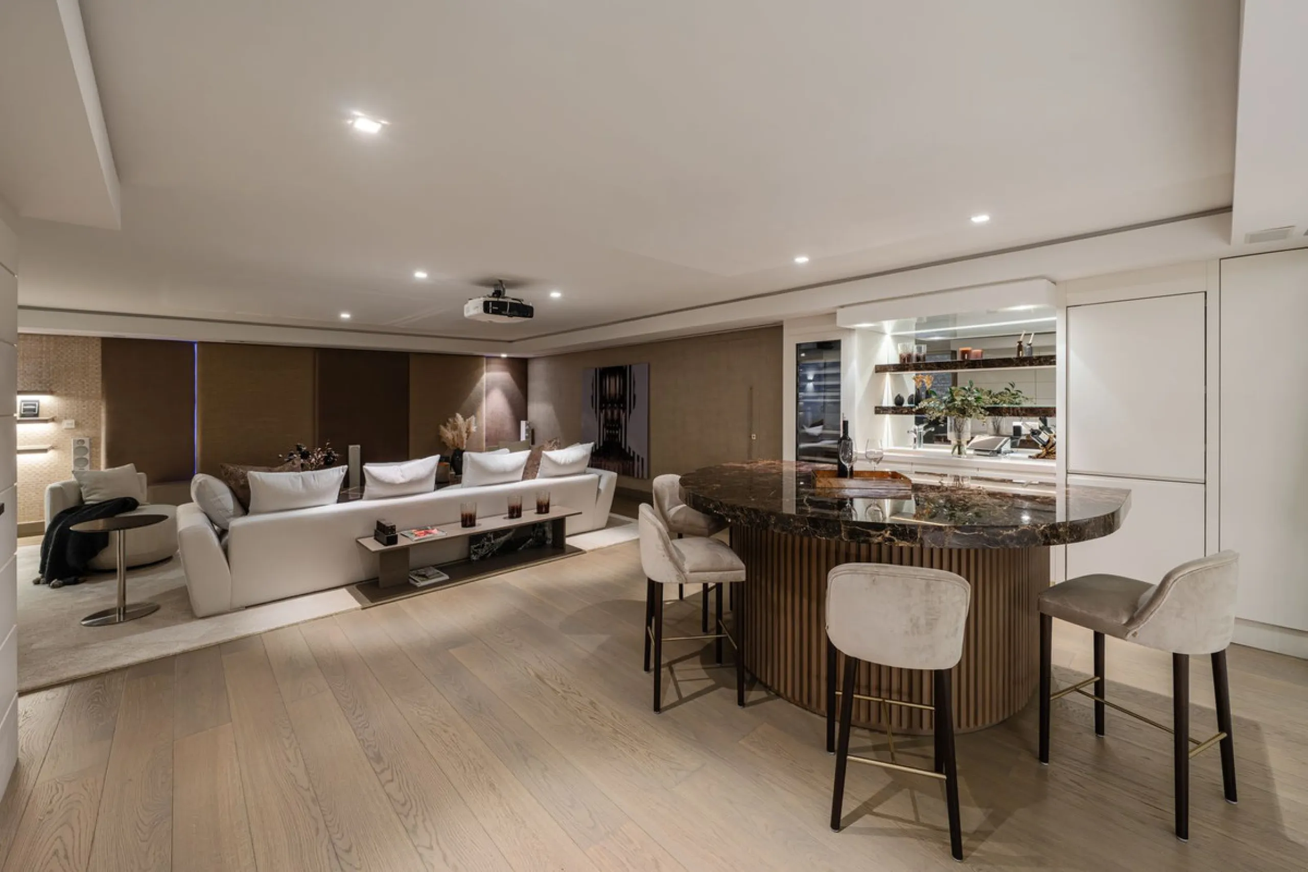 A semi-detached villa in the urbanisation, four bedrooms, four bathrooms, arranged with intent rather than habit: basement level below, an entrance floor with three en-suite bedrooms and a calm water feature setting the tone, a first floor dedicated entir