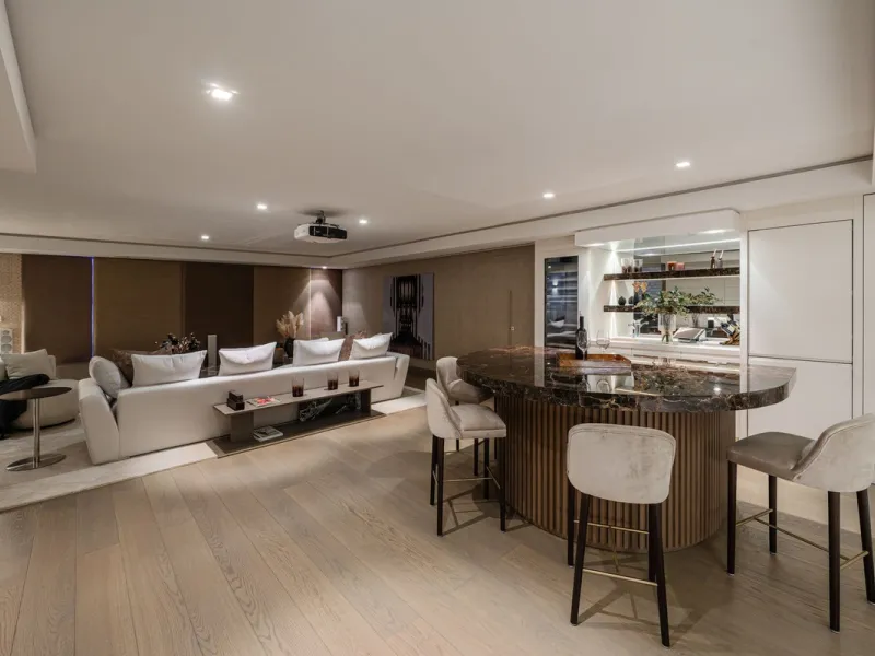 A semi-detached villa in the urbanisation, four bedrooms, four bathrooms, arranged with intent rather than habit: basement level below, an entrance floor with three en-suite bedrooms and a calm water feature setting the tone, a first floor dedicated entir