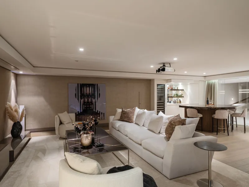 A semi-detached villa in the urbanisation, four bedrooms, four bathrooms, arranged with intent rather than habit: basement level below, an entrance floor with three en-suite bedrooms and a calm water feature setting the tone, a first floor dedicated entir