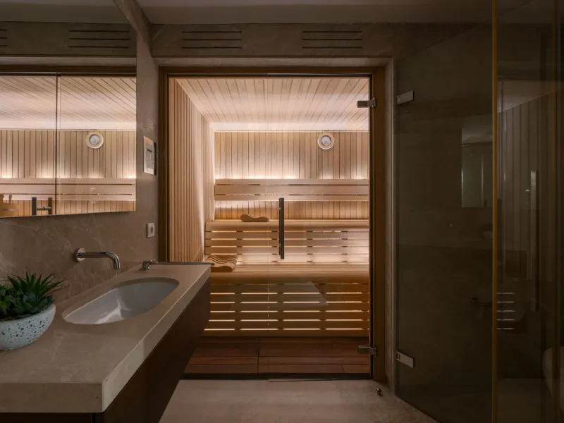 A semi-detached villa in the urbanisation, four bedrooms, four bathrooms, arranged with intent rather than habit: basement level below, an entrance floor with three en-suite bedrooms and a calm water feature setting the tone, a first floor dedicated entir
