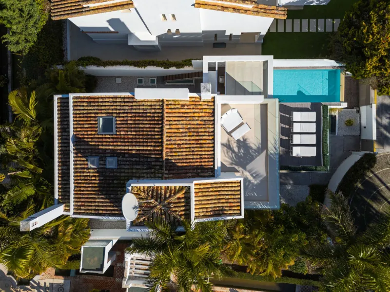 A semi-detached villa in the urbanisation, four bedrooms, four bathrooms, arranged with intent rather than habit: basement level below, an entrance floor with three en-suite bedrooms and a calm water feature setting the tone, a first floor dedicated entir