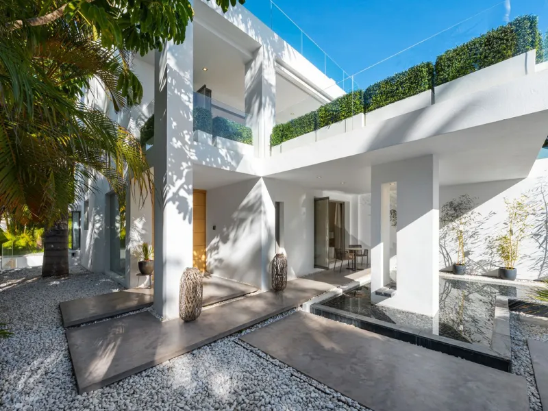 A semi-detached villa in the urbanisation, four bedrooms, four bathrooms, arranged with intent rather than habit: basement level below, an entrance floor with three en-suite bedrooms and a calm water feature setting the tone, a first floor dedicated entir
