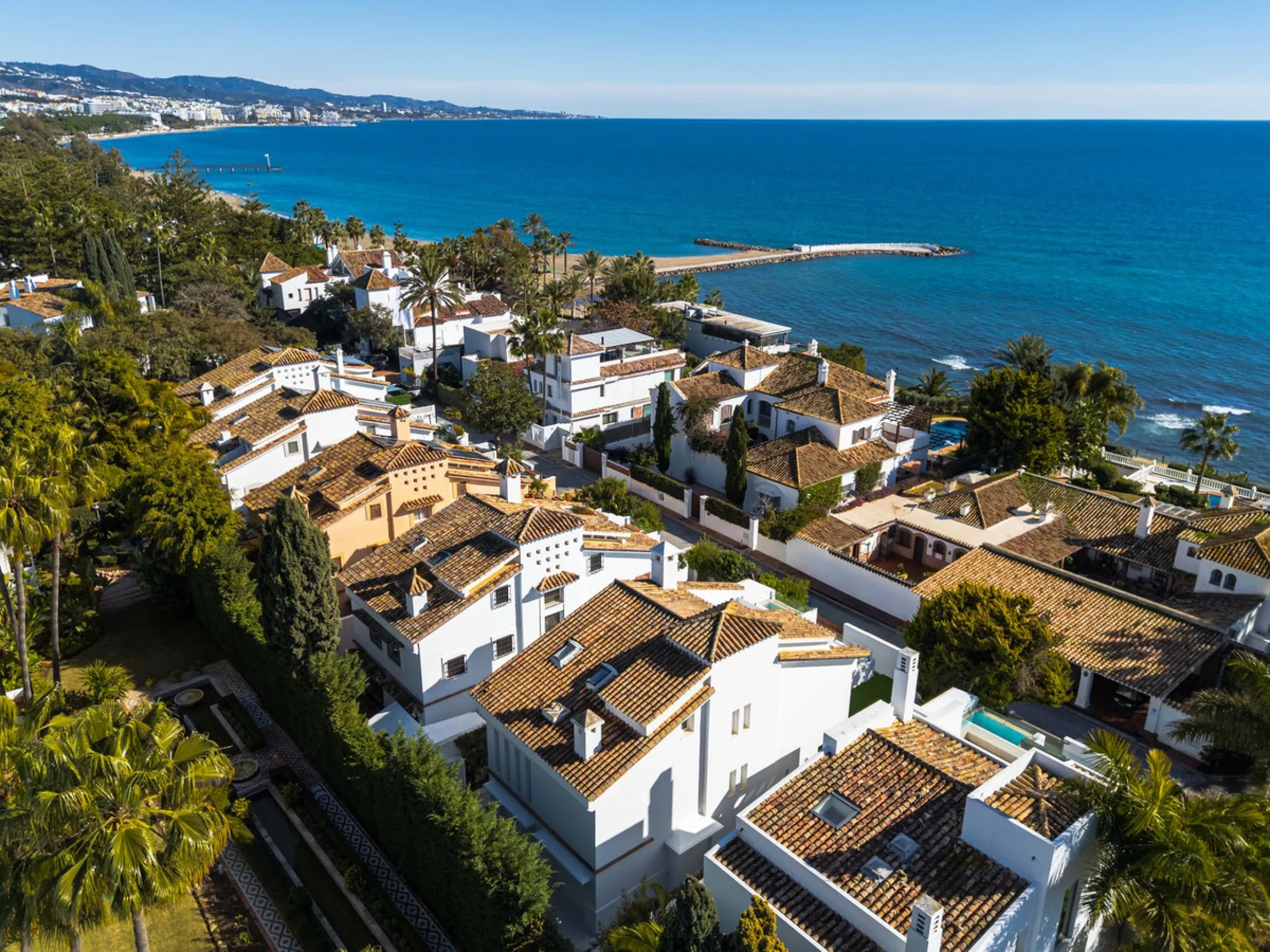 A semi-detached villa in the urbanisation, four bedrooms, four bathrooms, arranged with intent rather than habit: basement level below, an entrance floor with three en-suite bedrooms and a calm water feature setting the tone, a first floor dedicated entir