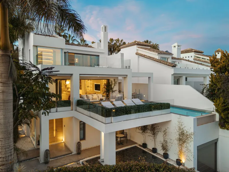 A semi-detached villa in the urbanisation, four bedrooms, four bathrooms, arranged with intent rather than habit: basement level below, an entrance floor with three en-suite bedrooms and a calm water feature setting the tone, a first floor dedicated entir