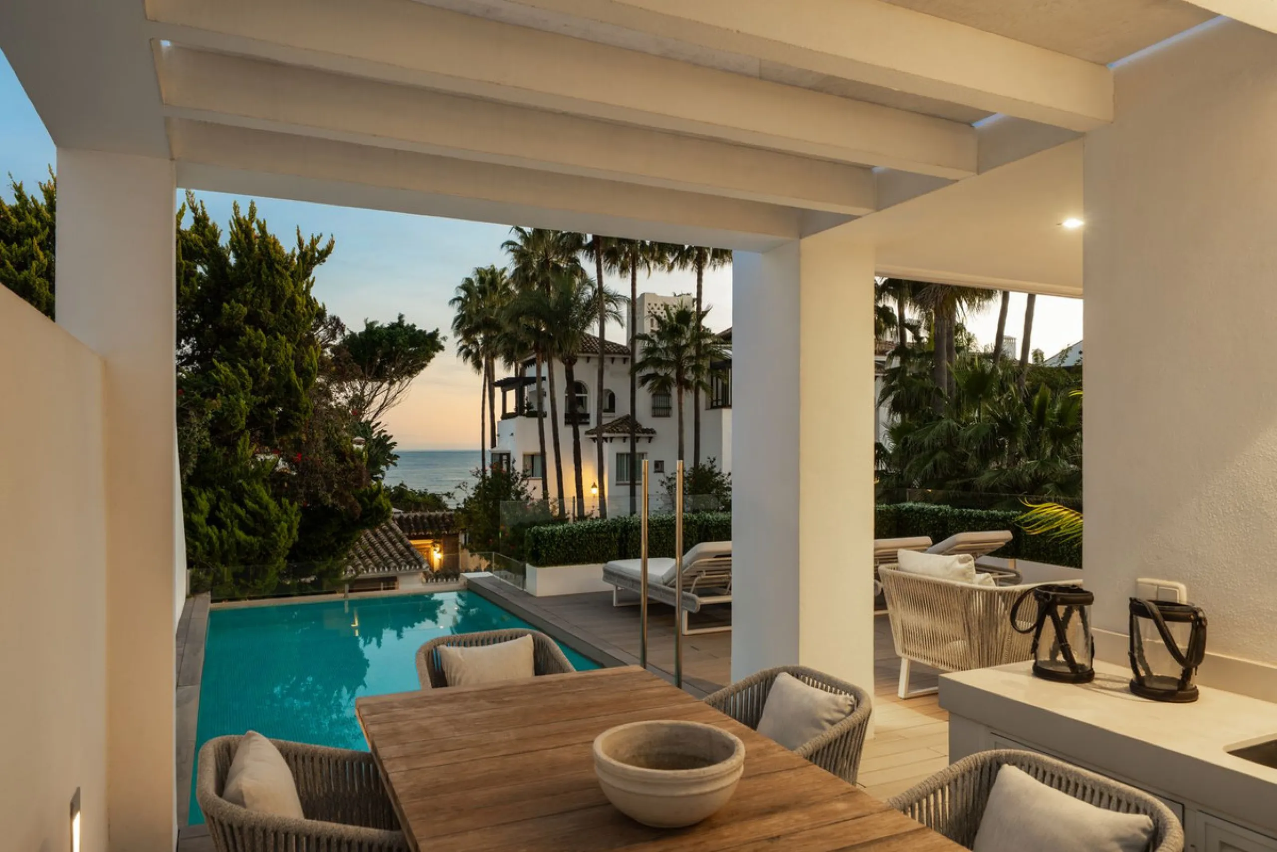 A semi-detached villa in the urbanisation, four bedrooms, four bathrooms, arranged with intent rather than habit: basement level below, an entrance floor with three en-suite bedrooms and a calm water feature setting the tone, a first floor dedicated entir