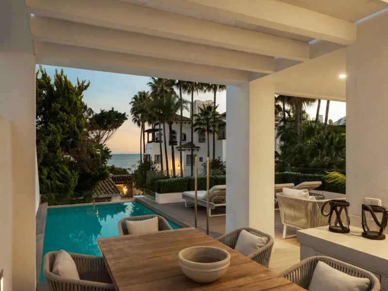 A semi-detached villa in the urbanisation, four bedrooms, four bathrooms, arranged with intent rather than habit: basement level below, an entrance floor with three en-suite bedrooms and a calm water feature setting the tone, a first floor dedicated entir