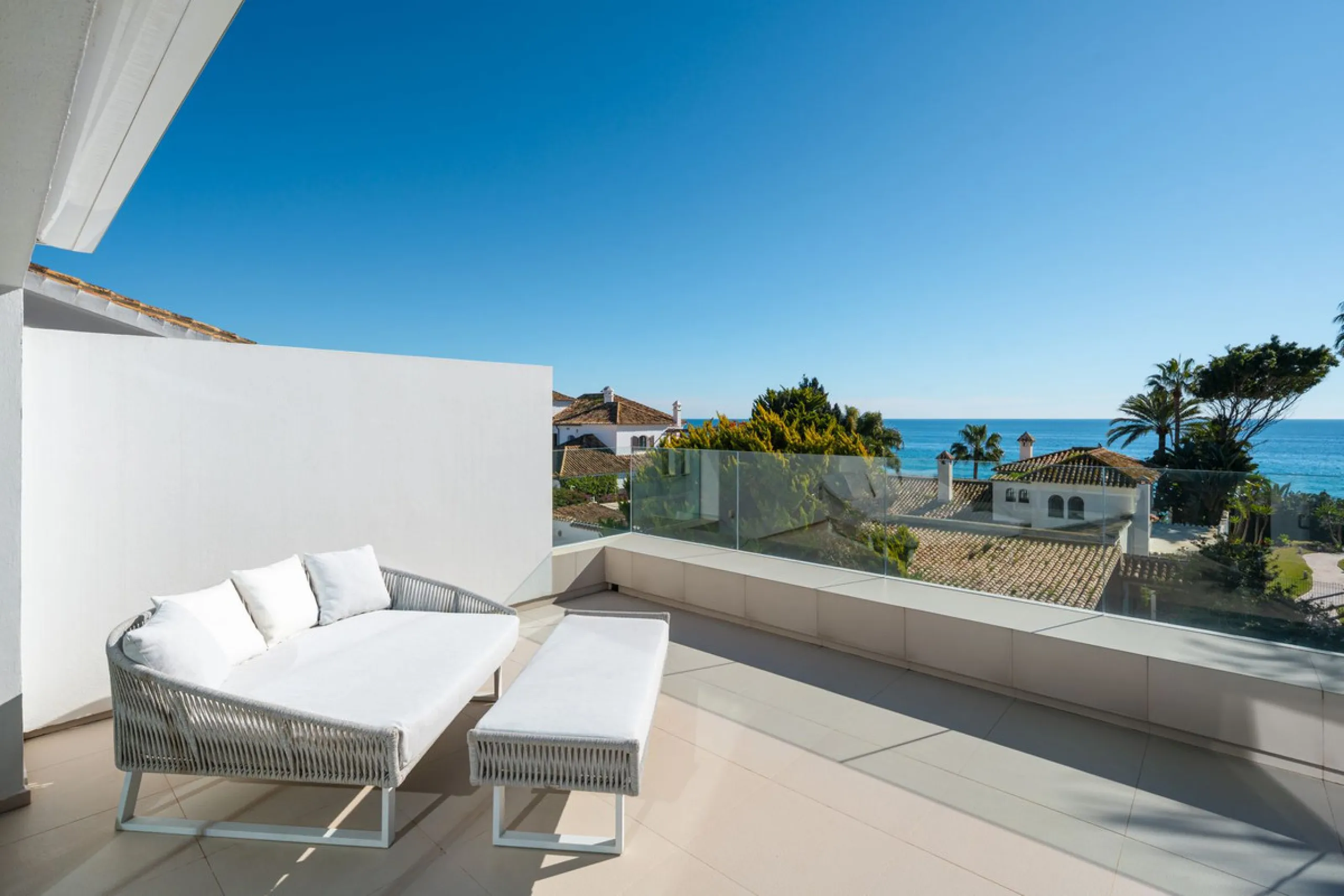 A semi-detached villa in the urbanisation, four bedrooms, four bathrooms, arranged with intent rather than habit: basement level below, an entrance floor with three en-suite bedrooms and a calm water feature setting the tone, a first floor dedicated entir