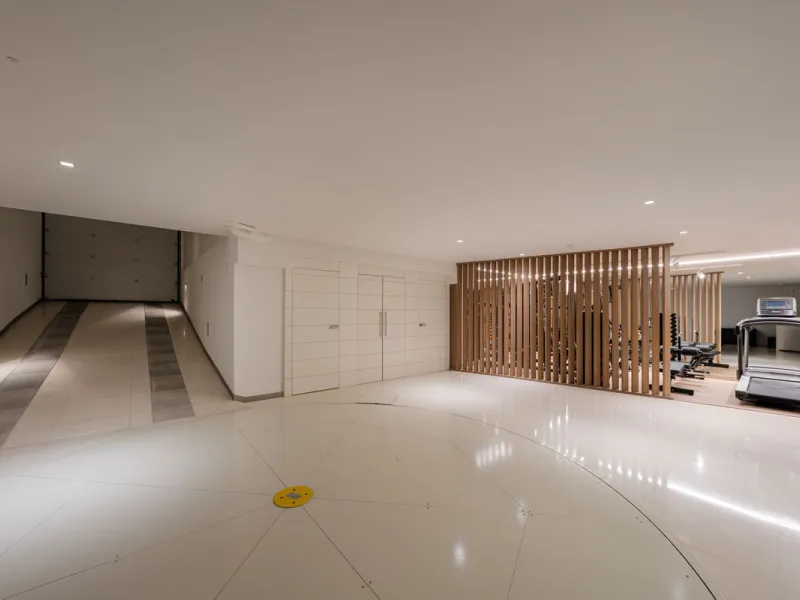 A semi-detached villa in the urbanisation, four bedrooms, four bathrooms, arranged with intent rather than habit: basement level below, an entrance floor with three en-suite bedrooms and a calm water feature setting the tone, a first floor dedicated entir