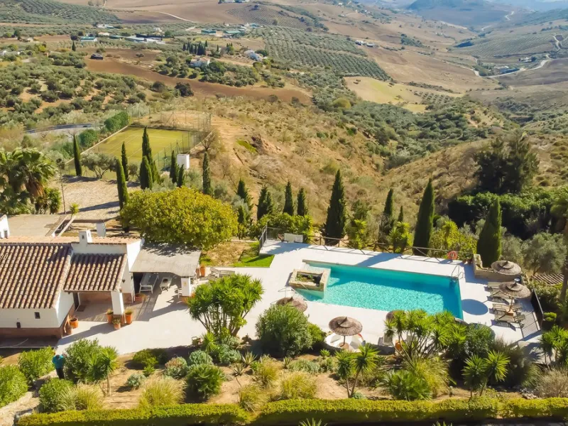 This exceptional Andalusian estate, located in the charming village of Villanueva de la Concepción, offers a rare combination of space, privacy, and breathtaking surroundings. The main residence includes 11 beautifully renovated bedrooms, comfortably acco
