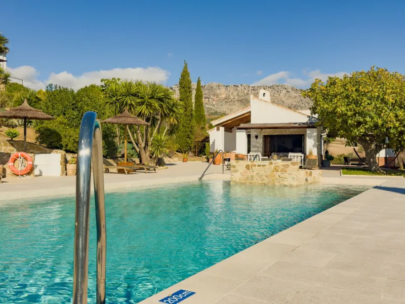 This exceptional Andalusian estate, located in the charming village of Villanueva de la Concepción, offers a rare combination of space, privacy, and breathtaking surroundings. The main residence includes 11 beautifully renovated bedrooms, comfortably acco