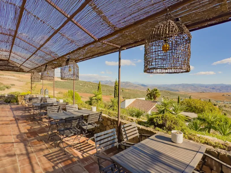 This exceptional Andalusian estate, located in the charming village of Villanueva de la Concepción, offers a rare combination of space, privacy, and breathtaking surroundings. The main residence includes 11 beautifully renovated bedrooms, comfortably acco