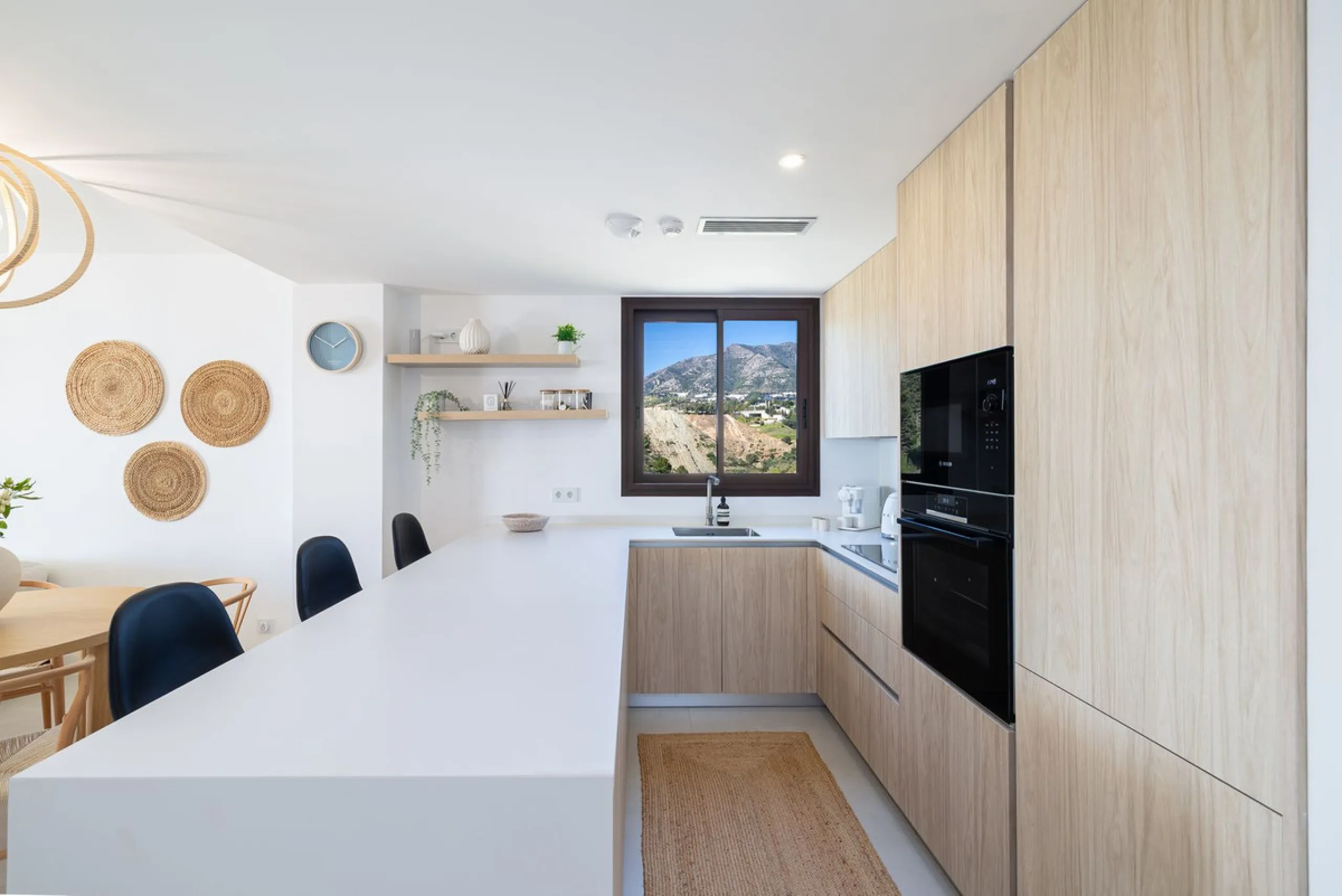 Finding the perfect balance between coastal serenity and modern luxury is effortless in this stunning corner residence, located in the highly sought-after lower enclave of El Higuerón, Fuengirola. This exceptionally spacious and luminous home is designed 