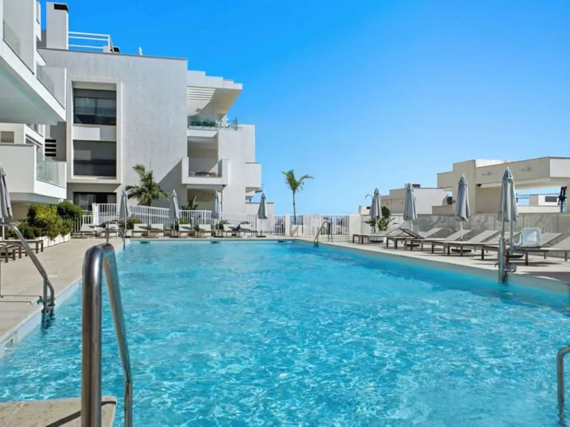 Set within the dynamic and increasingly sought-after residential quarter of Las Mesas in Estepona, this elegant elevated ground-floor apartment represents a rare convergence of urban accessibility, privacy, and long-term investment appeal. Positioned just