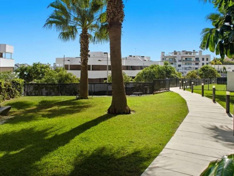 Set within the dynamic and increasingly sought-after residential quarter of Las Mesas in Estepona, this elegant elevated ground-floor apartment represents a rare convergence of urban accessibility, privacy, and long-term investment appeal. Positioned just