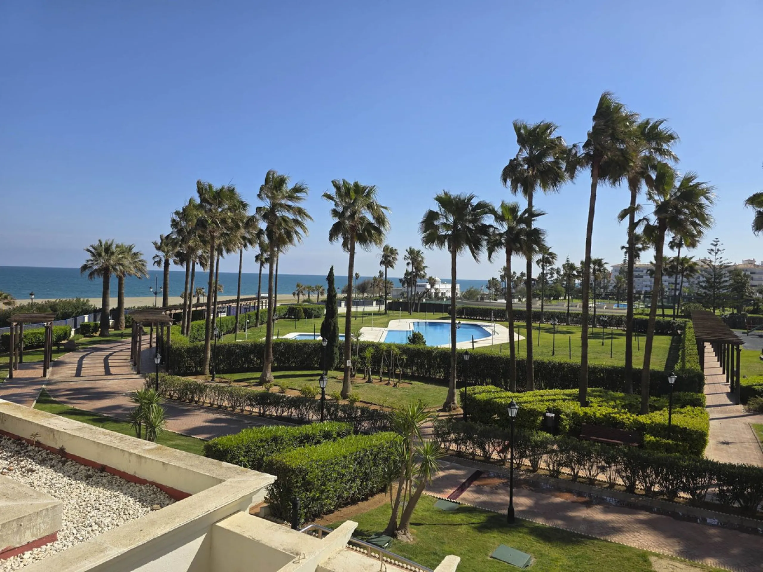 2-bedroom beachfront apartment with terrace, sea views, gardens, and pool, in the best urbanization of Sabinillas, in an unbeatable location within walking distance of all amenities.