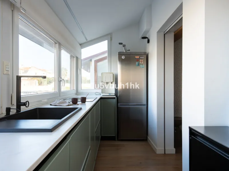 Discover a rare opportunity to own two beautifully designed homes combined on one generous plot in the heart of Vélez-Málaga — complete with private parking, a swimming pool, extensive entertainment areas, and a substantial commercial premise generating €