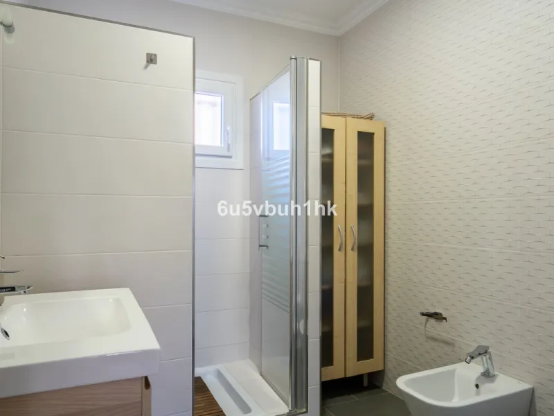 Discover a rare opportunity to own two beautifully designed homes combined on one generous plot in the heart of Vélez-Málaga — complete with private parking, a swimming pool, extensive entertainment areas, and a substantial commercial premise generating €