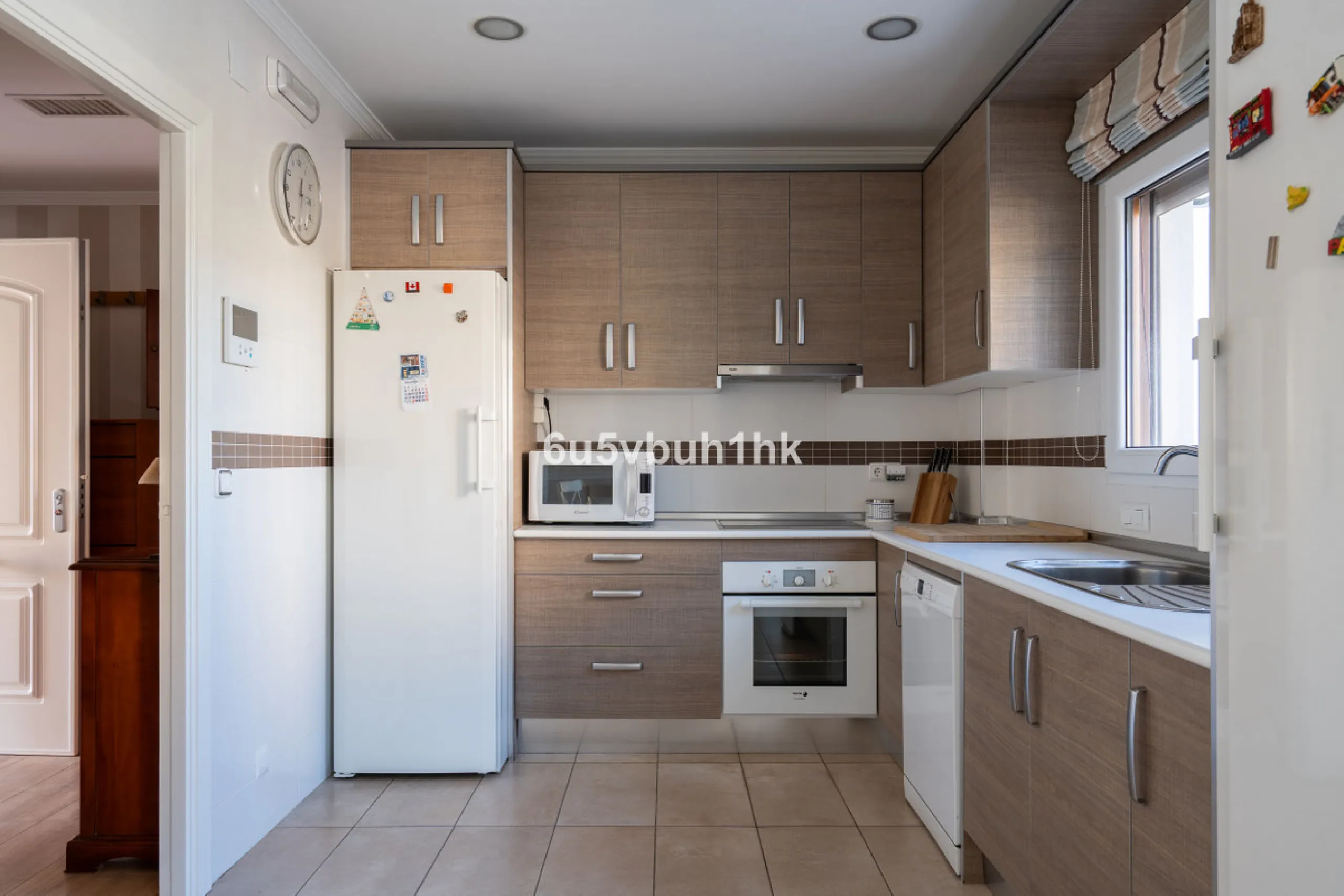 Discover a rare opportunity to own two beautifully designed homes combined on one generous plot in the heart of Vélez-Málaga — complete with private parking, a swimming pool, extensive entertainment areas, and a substantial commercial premise generating €