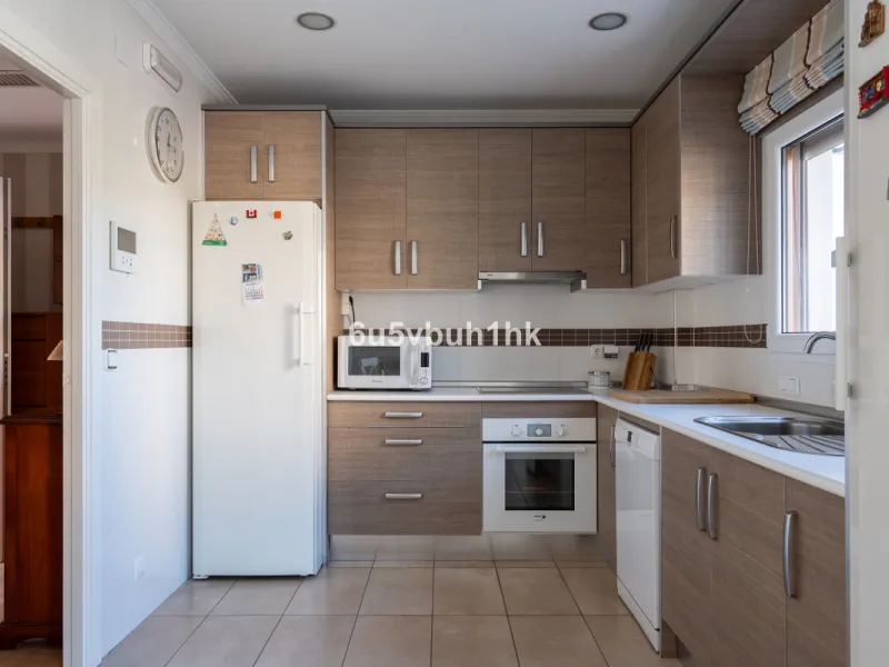 Discover a rare opportunity to own two beautifully designed homes combined on one generous plot in the heart of Vélez-Málaga — complete with private parking, a swimming pool, extensive entertainment areas, and a substantial commercial premise generating €