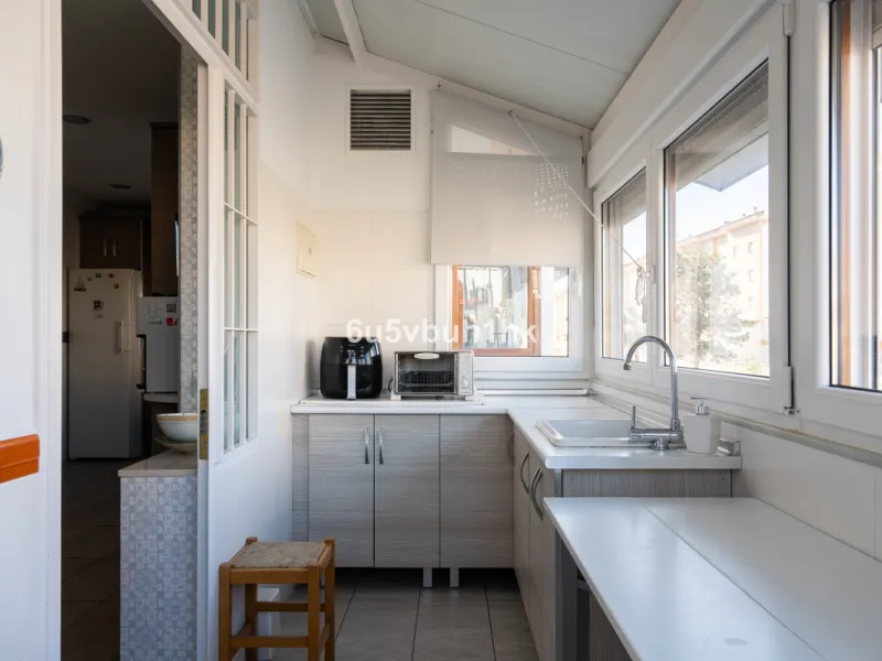 Discover a rare opportunity to own two beautifully designed homes combined on one generous plot in the heart of Vélez-Málaga — complete with private parking, a swimming pool, extensive entertainment areas, and a substantial commercial premise generating €