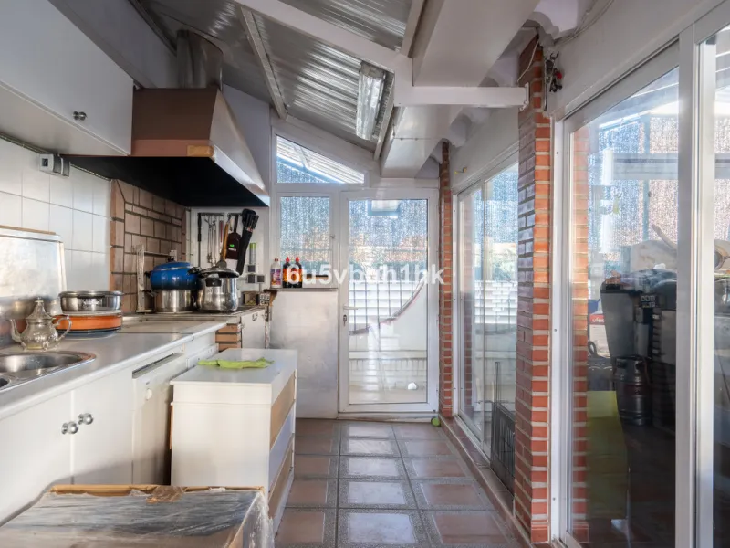 Discover a rare opportunity to own two beautifully designed homes combined on one generous plot in the heart of Vélez-Málaga — complete with private parking, a swimming pool, extensive entertainment areas, and a substantial commercial premise generating €