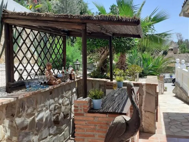A large villa  in a quiet cul de sac in the Urbanisation of Campo Mijas with a large walled and gated garden with ample parking space for 3 or 4 cars . The property is entered via a gated entrance way to the large parking area with easy access to  the hou