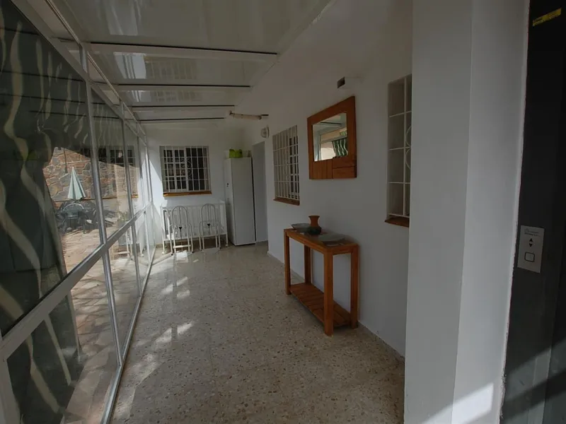 A large villa  in a quiet cul de sac in the Urbanisation of Campo Mijas with a large walled and gated garden with ample parking space for 3 or 4 cars . The property is entered via a gated entrance way to the large parking area with easy access to  the hou