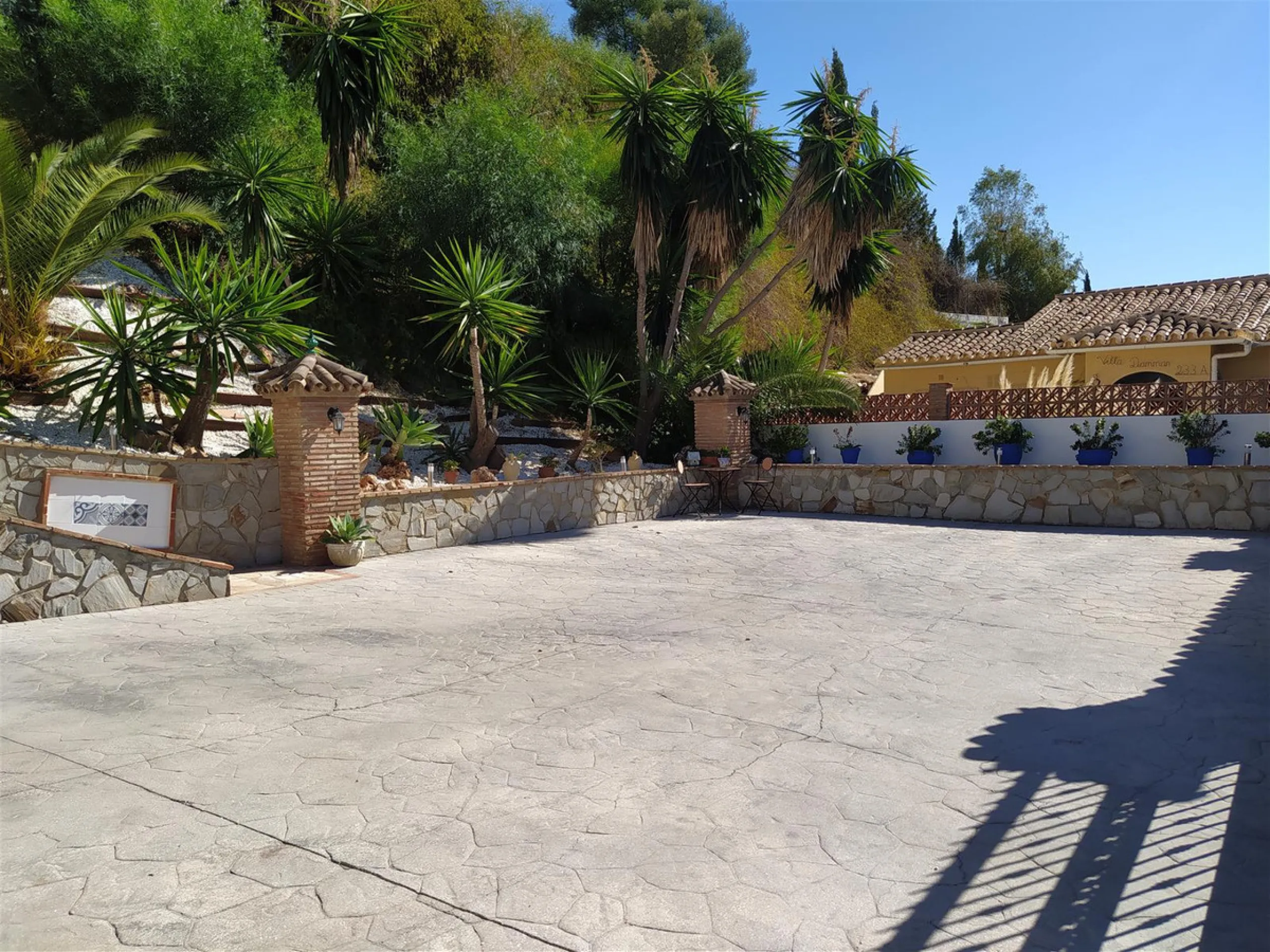 A large villa  in a quiet cul de sac in the Urbanisation of Campo Mijas with a large walled and gated garden with ample parking space for 3 or 4 cars . The property is entered via a gated entrance way to the large parking area with easy access to  the hou
