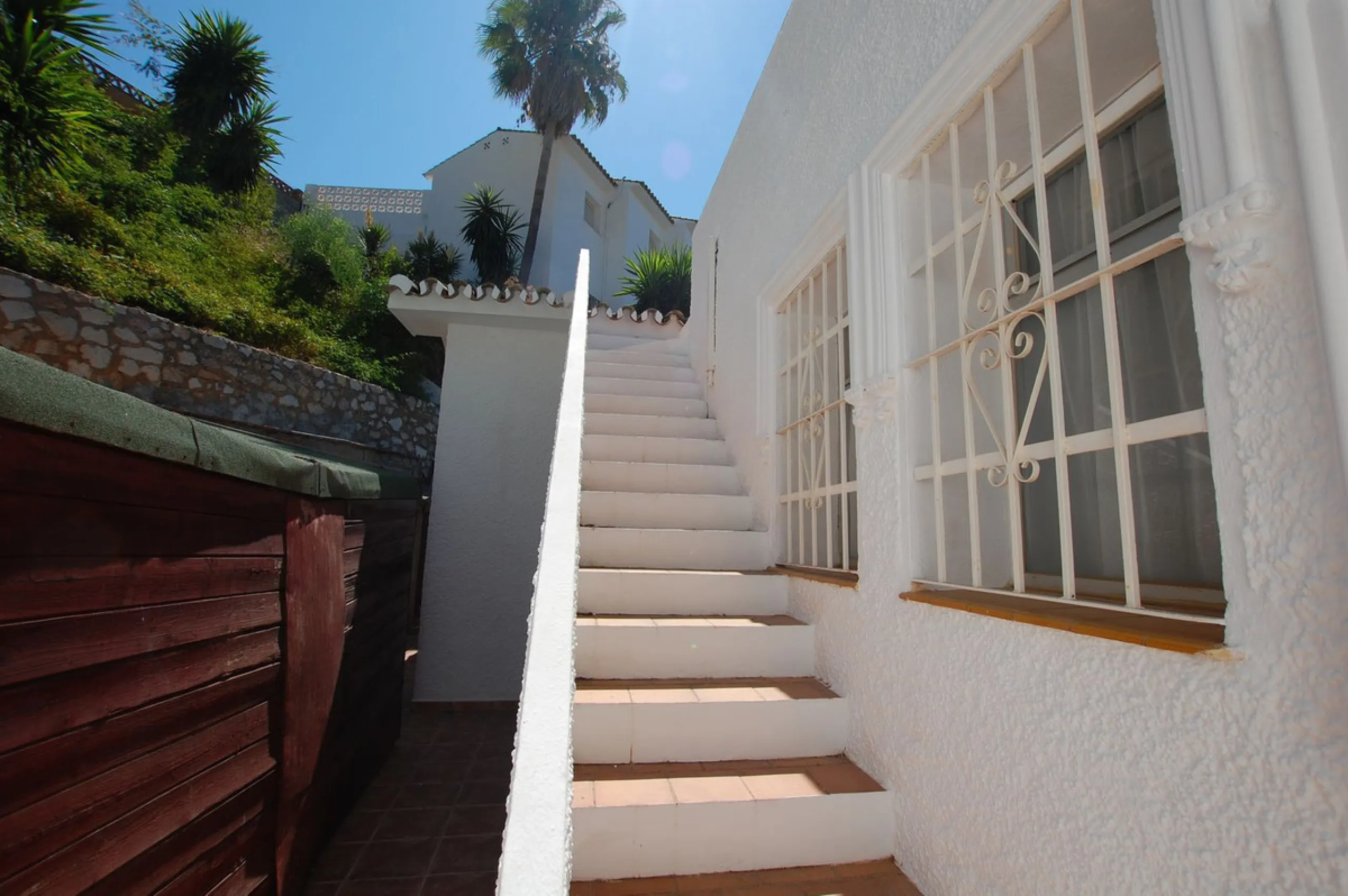 A large villa  in a quiet cul de sac in the Urbanisation of Campo Mijas with a large walled and gated garden with ample parking space for 3 or 4 cars . The property is entered via a gated entrance way to the large parking area with easy access to  the hou