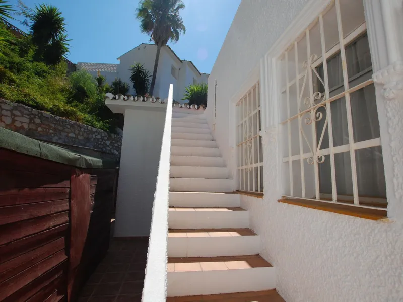 A large villa  in a quiet cul de sac in the Urbanisation of Campo Mijas with a large walled and gated garden with ample parking space for 3 or 4 cars . The property is entered via a gated entrance way to the large parking area with easy access to  the hou