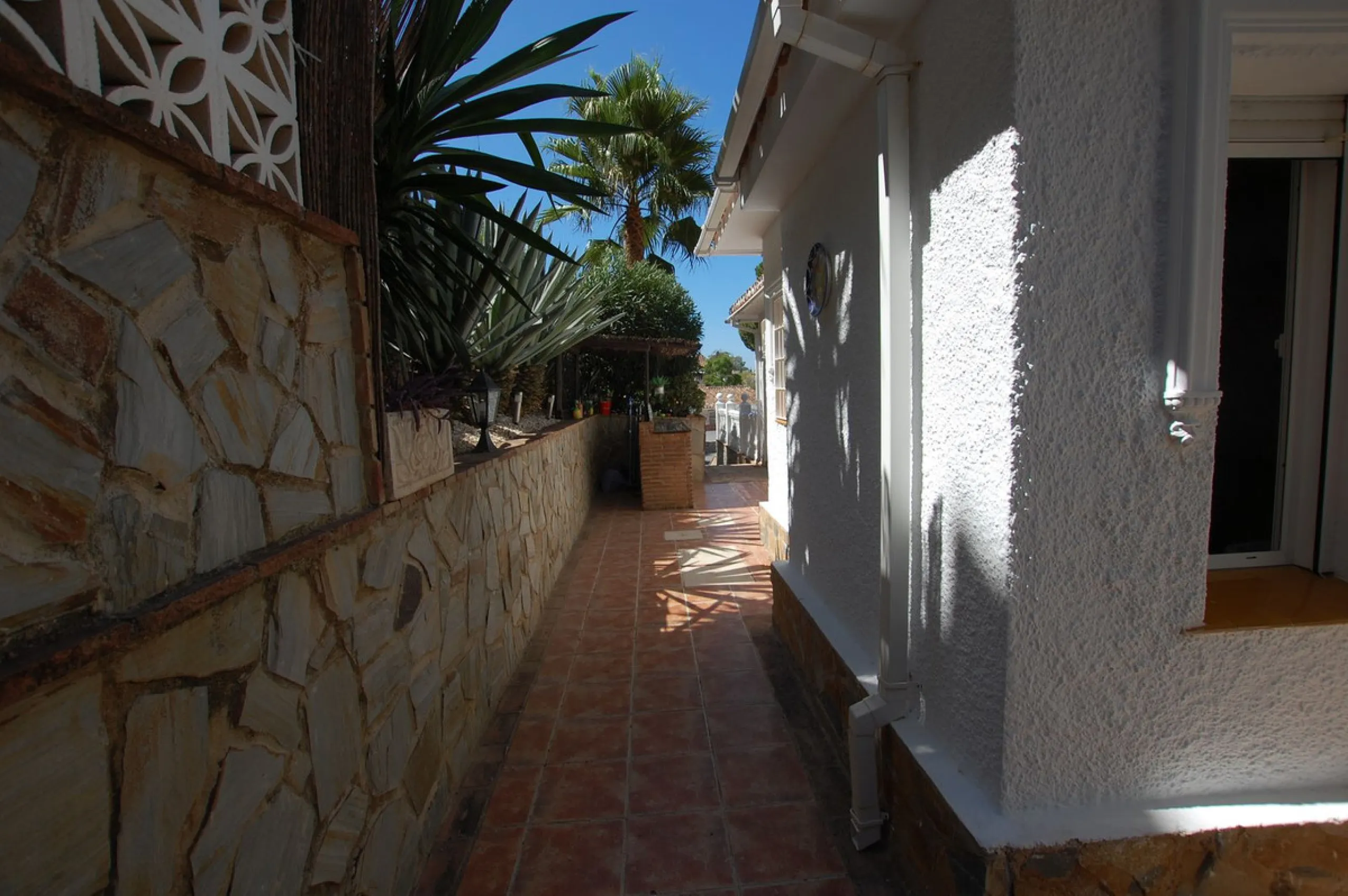 A large villa  in a quiet cul de sac in the Urbanisation of Campo Mijas with a large walled and gated garden with ample parking space for 3 or 4 cars . The property is entered via a gated entrance way to the large parking area with easy access to  the hou