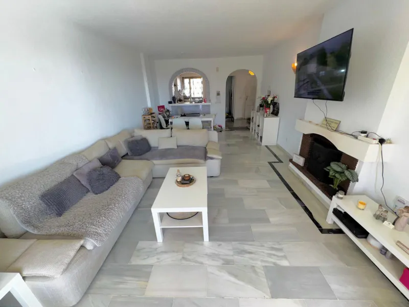 This fantastic two-bedroom, southwest-facing first-floor apartment in Calahonda offers beautiful sea views and an abundance of natural light throughout the day. The property features a bright and spacious living area complete with a charming fireplace, cr