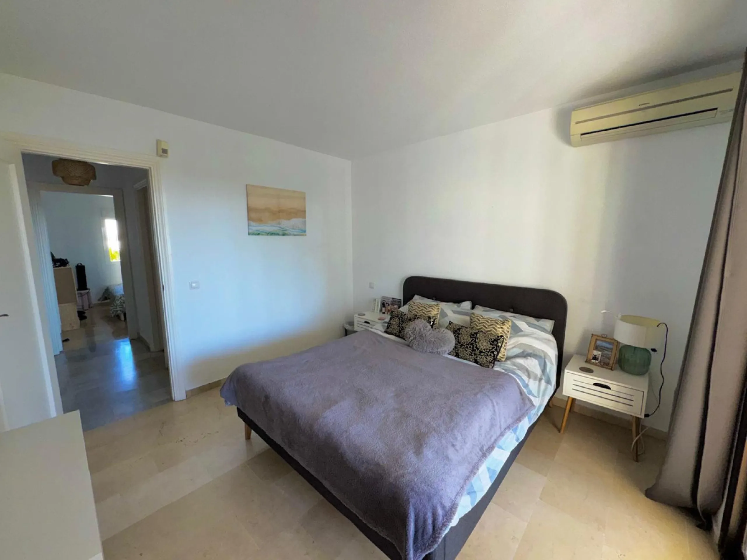 This fantastic two-bedroom, southwest-facing first-floor apartment in Calahonda offers beautiful sea views and an abundance of natural light throughout the day. The property features a bright and spacious living area complete with a charming fireplace, cr