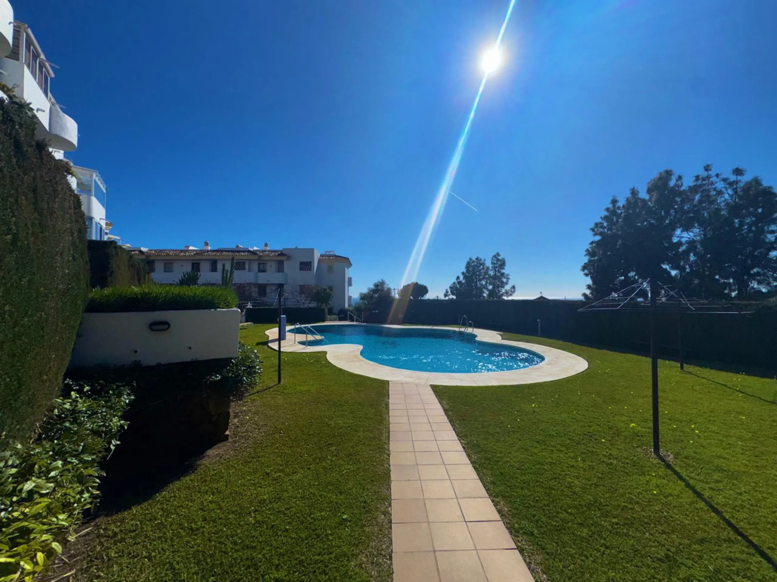 This fantastic two-bedroom, southwest-facing first-floor apartment in Calahonda offers beautiful sea views and an abundance of natural light throughout the day. The property features a bright and spacious living area complete with a charming fireplace, cr