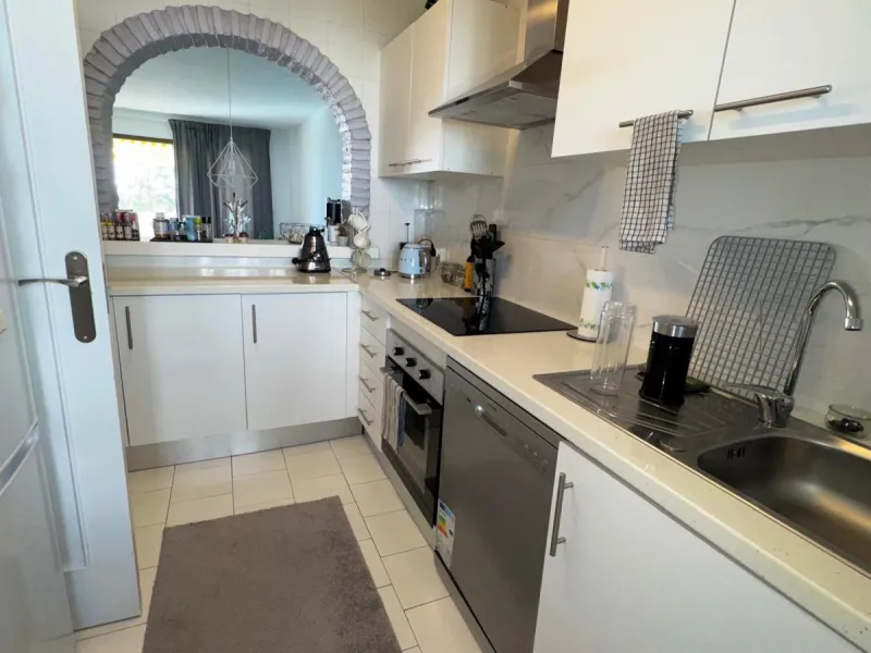 This fantastic two-bedroom, southwest-facing first-floor apartment in Calahonda offers beautiful sea views and an abundance of natural light throughout the day. The property features a bright and spacious living area complete with a charming fireplace, cr