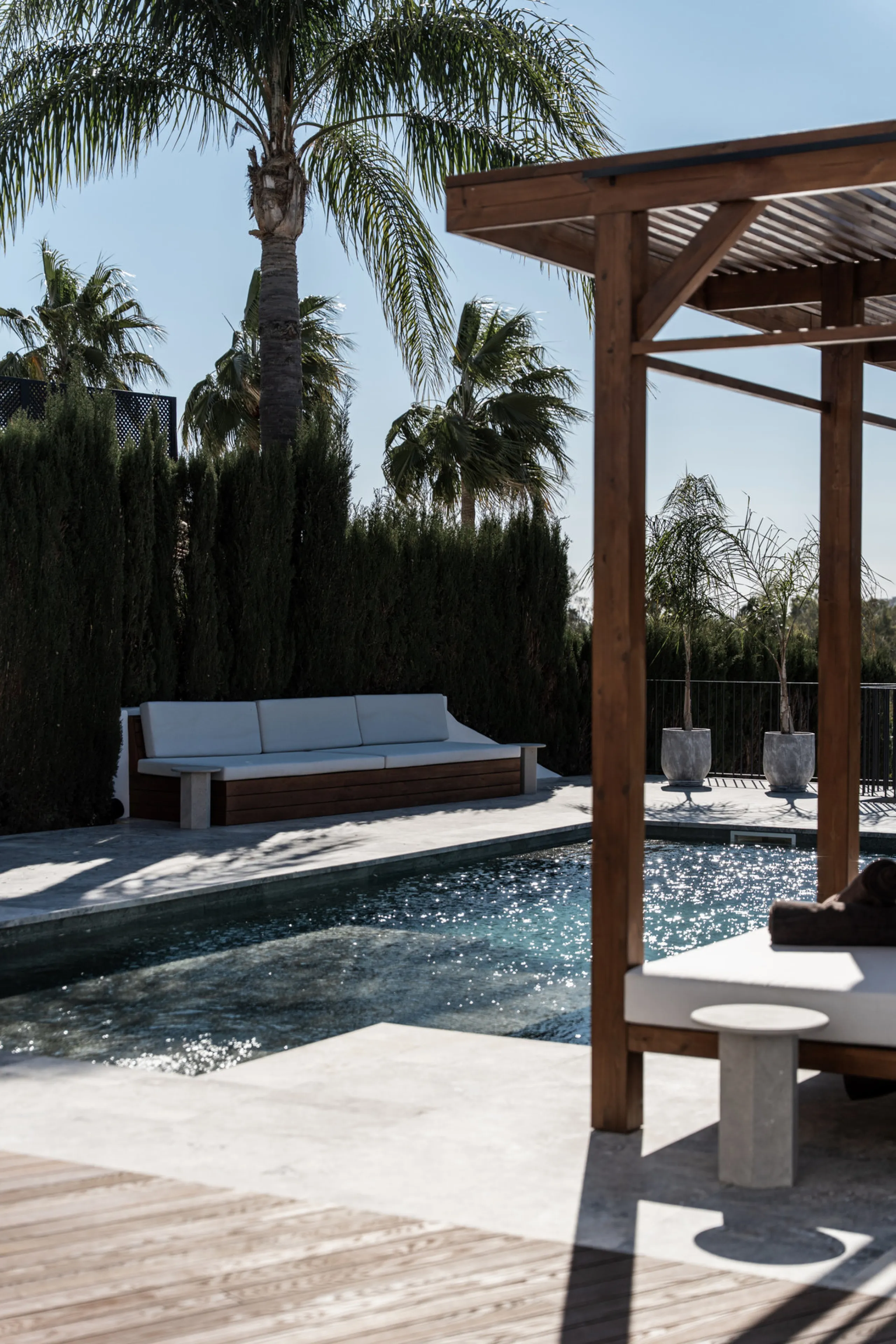 A four-bedroom villa in Nueva Andalucía with open golf and sea views, arranged over multiple levels with a garden-level pool, integrated outdoor kitchen, generous terraces and a private garage.