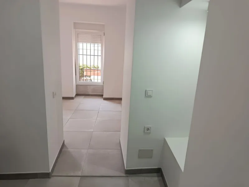 Located just a few minutes' walk from the centre of Alhaurín el Grande, this beautifully renovated apartment perfectly blends traditional charm with a modern, minimalist style.