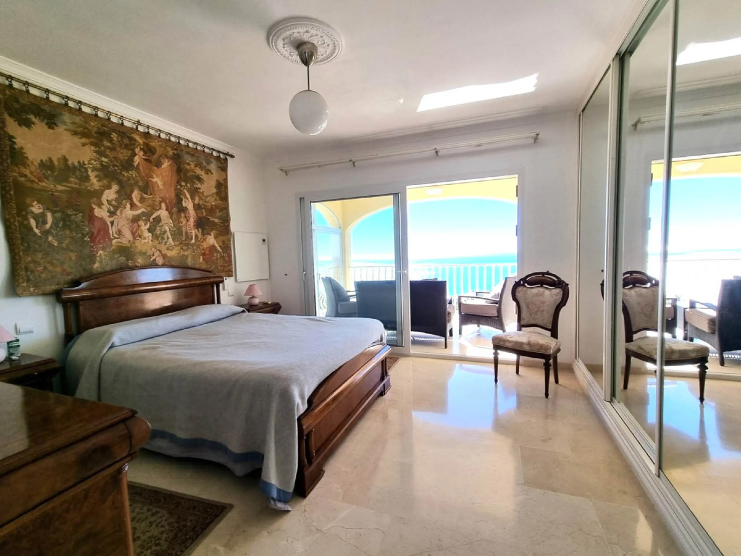 Located in the prestigious La Capellania area of the Costa del Sol, this exceptional 5-bedroom villa masterfully blends modern luxury with timeless Mediterranean charm, offering breathtaking panoramic sea views and an enviable lifestyle in one of southern
