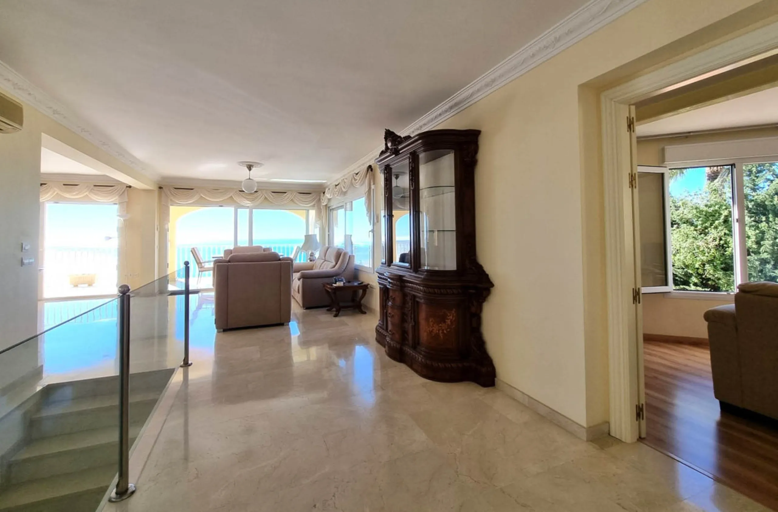 Located in the prestigious La Capellania area of the Costa del Sol, this exceptional 5-bedroom villa masterfully blends modern luxury with timeless Mediterranean charm, offering breathtaking panoramic sea views and an enviable lifestyle in one of southern