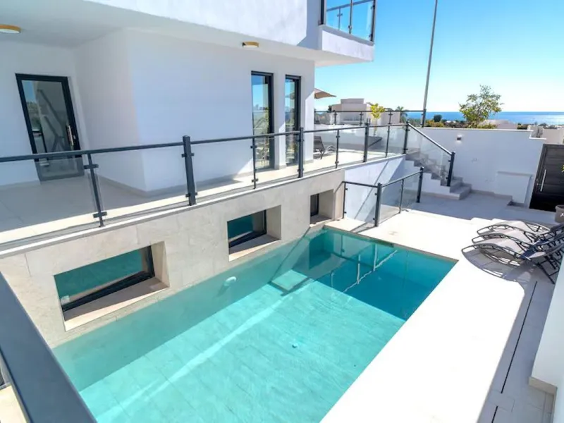 This elegant modern villa blends clean architectural lines with a warm, comfortable feel, set within a quiet residential area just outside Nerja. From its elevated position, the property enjoys spectacular views of both the sea and surrounding mountains.