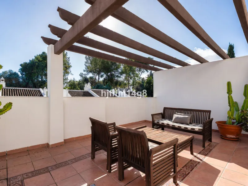 This stunning 3-bedroom townhouse is for sale in the highly sought-after El Alcornoque urbanisation in Nueva Andalucía, one of Marbella's most prestigious areas. Nestled front line to the renowned Aloha Golf Course, this exclusive development of just 22 u