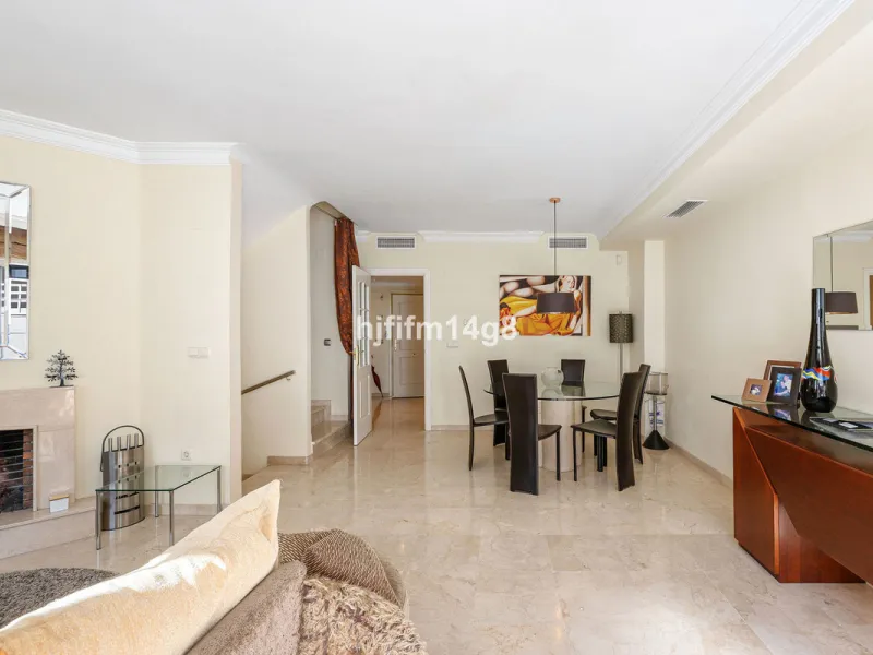 This stunning 3-bedroom townhouse is for sale in the highly sought-after El Alcornoque urbanisation in Nueva Andalucía, one of Marbella's most prestigious areas. Nestled front line to the renowned Aloha Golf Course, this exclusive development of just 22 u