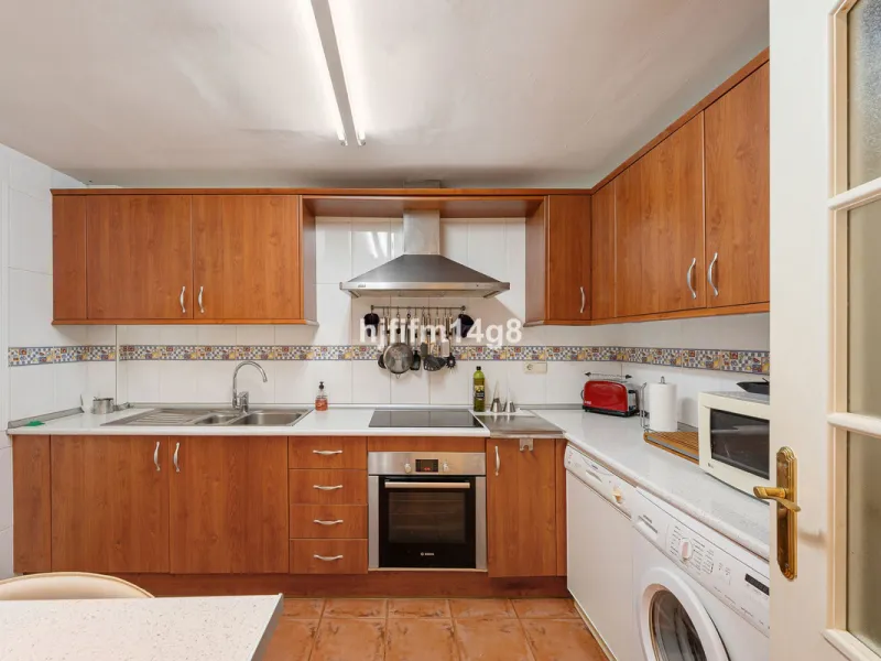 This stunning 3-bedroom townhouse is for sale in the highly sought-after El Alcornoque urbanisation in Nueva Andalucía, one of Marbella's most prestigious areas. Nestled front line to the renowned Aloha Golf Course, this exclusive development of just 22 u