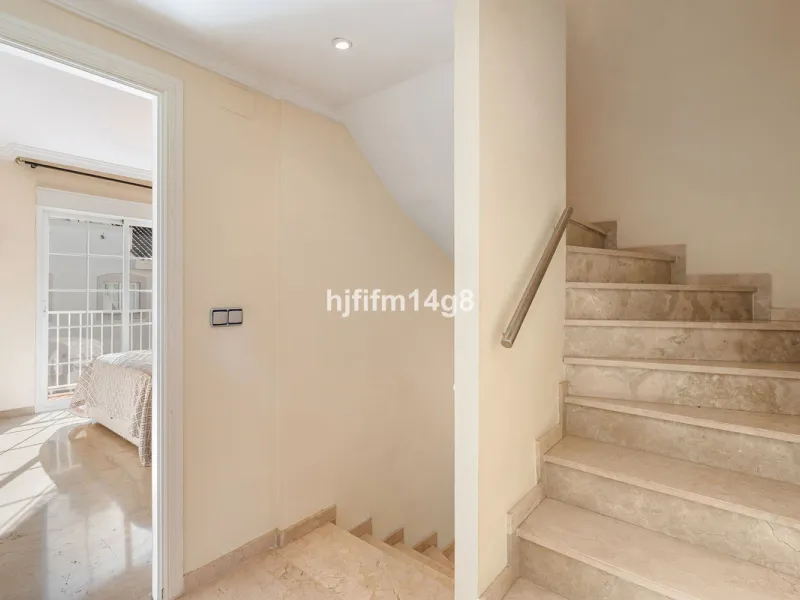 This stunning 3-bedroom townhouse is for sale in the highly sought-after El Alcornoque urbanisation in Nueva Andalucía, one of Marbella's most prestigious areas. Nestled front line to the renowned Aloha Golf Course, this exclusive development of just 22 u