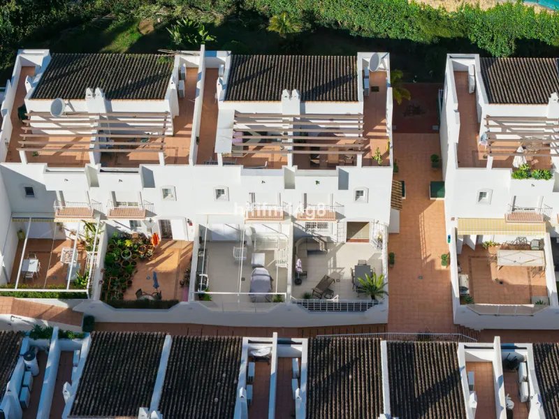 This stunning 3-bedroom townhouse is for sale in the highly sought-after El Alcornoque urbanisation in Nueva Andalucía, one of Marbella's most prestigious areas. Nestled front line to the renowned Aloha Golf Course, this exclusive development of just 22 u