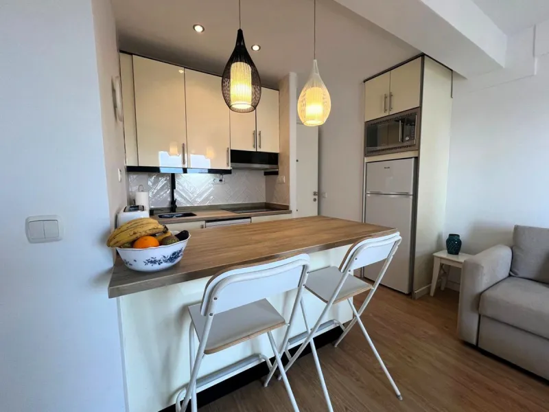 Discover a true beachfront gem in Calahonda. This fully renovated corner apartment, located on the front line of the beach, stands out for an exceptional and rarely found feature: a large wraparound terrace that surrounds almost the entire property, creat