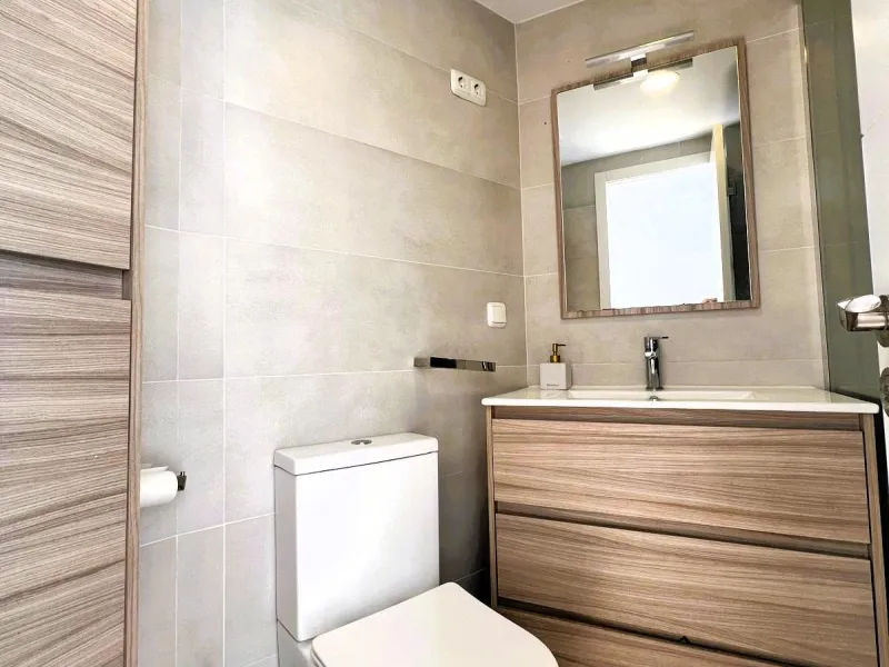 Discover a true beachfront gem in Calahonda. This fully renovated corner apartment, located on the front line of the beach, stands out for an exceptional and rarely found feature: a large wraparound terrace that surrounds almost the entire property, creat