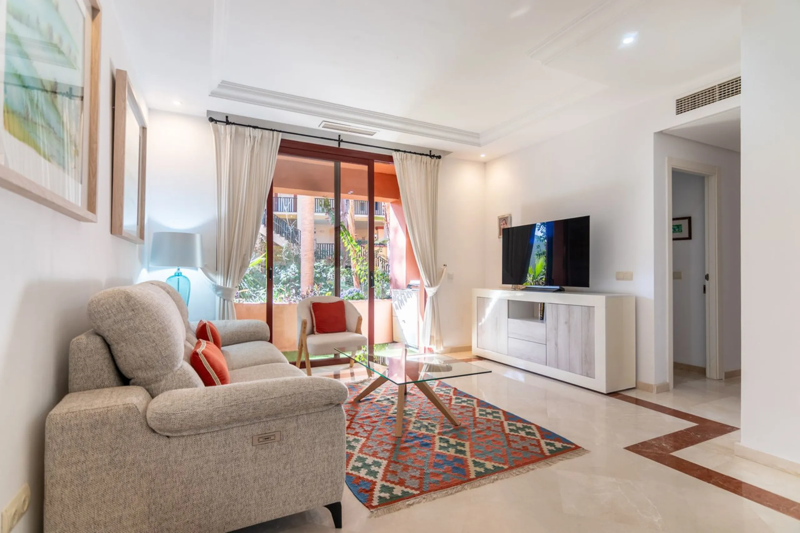An apartment with 3 bedrooms, 2 bathrooms, a spacious living room, and a new kitchen with a dining area overlooking a beautiful garden with a fountain. The property is located in a unique, lush residential community where the views from the terrace and wi