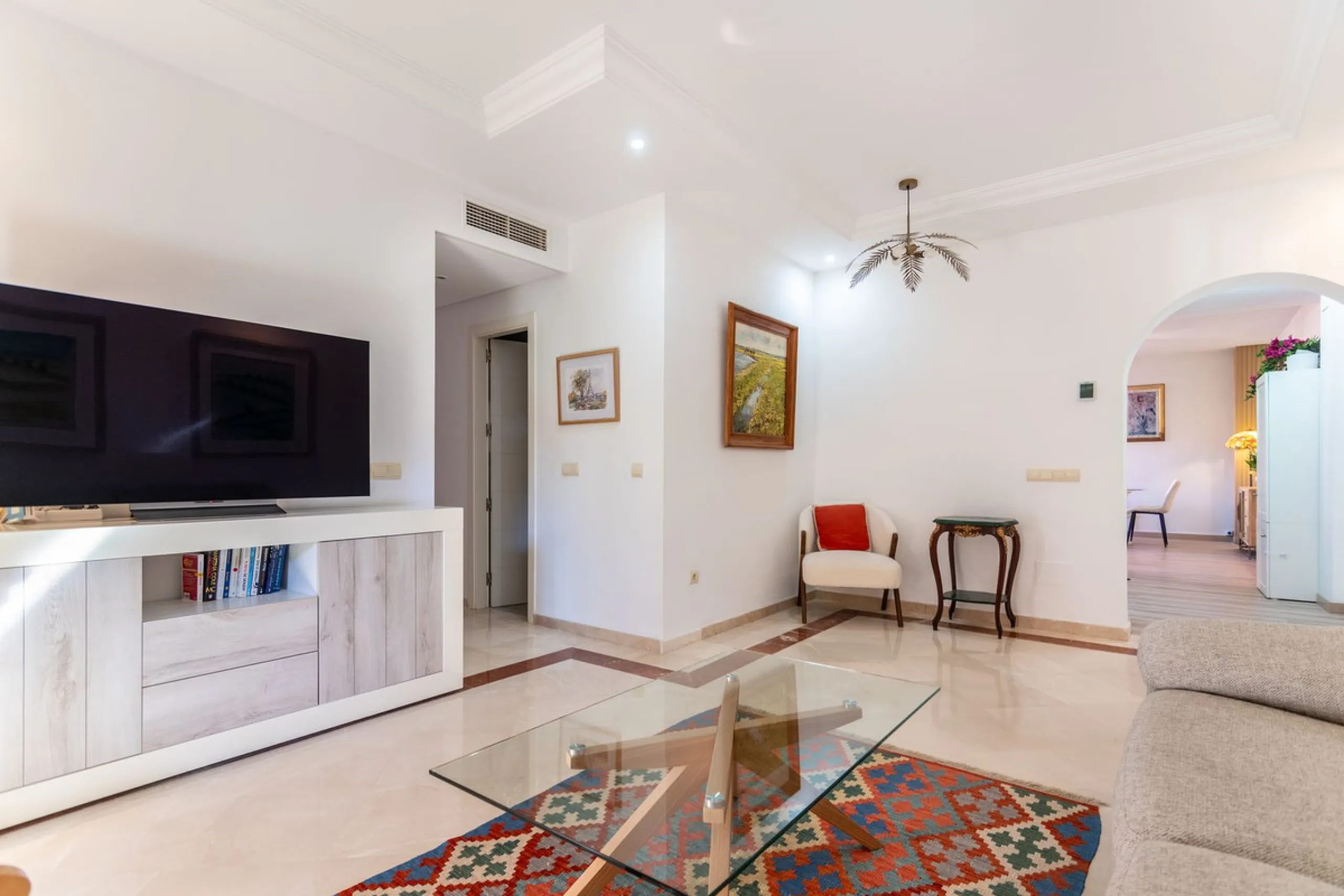 An apartment with 3 bedrooms, 2 bathrooms, a spacious living room, and a new kitchen with a dining area overlooking a beautiful garden with a fountain. The property is located in a unique, lush residential community where the views from the terrace and wi